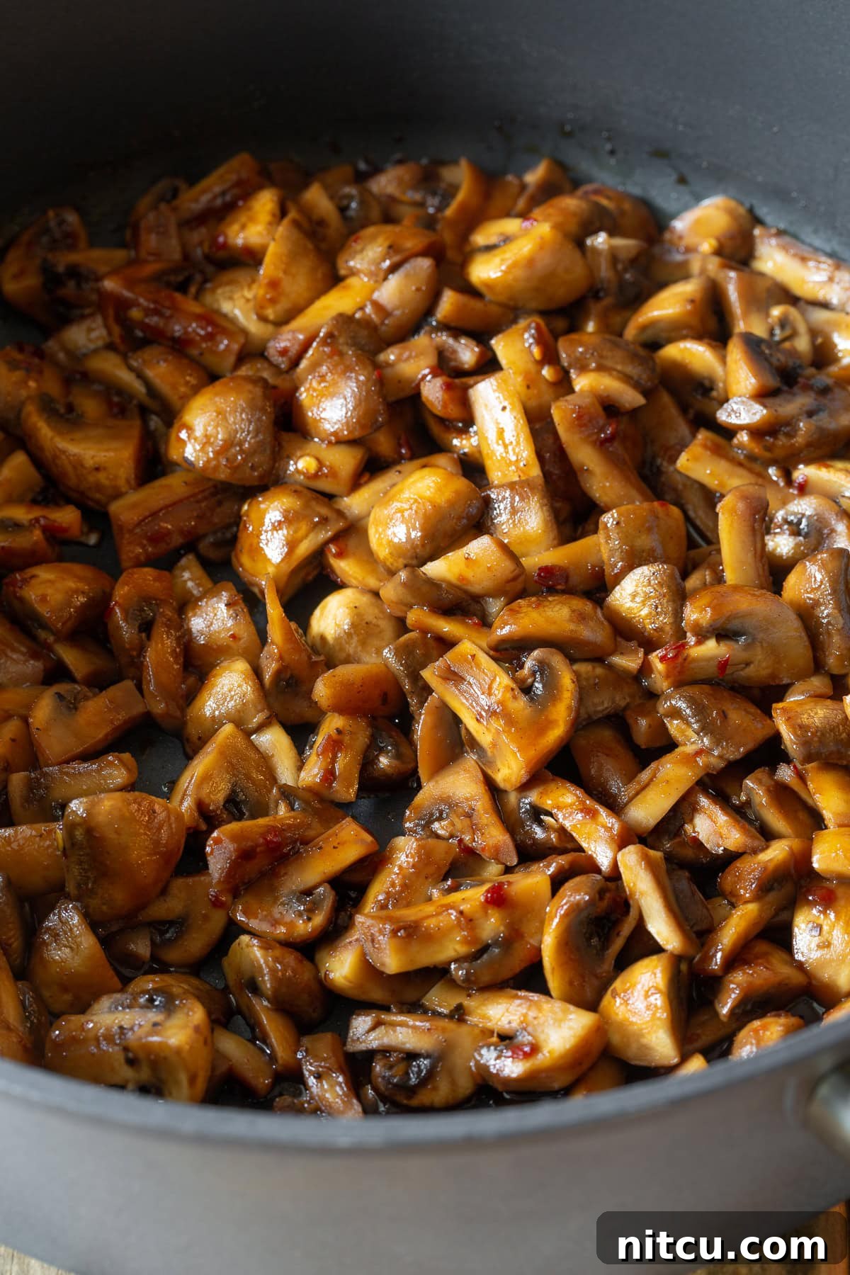 Mushroom Stir Fry #ASpicyPerspective #Mushrooms #StirFry #MushroomStirFry #AsianMushroom #Asian #SideDish #Vegetarian #Healthy #LowCarb #LowFat Asian stir-fried mushrooms in a large skillet.
