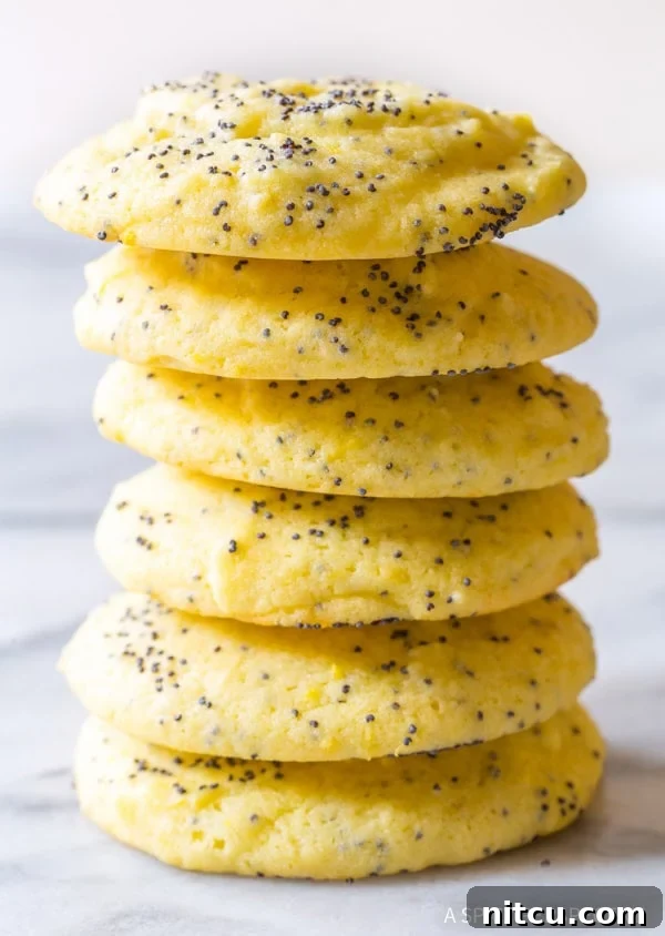 Soft Lemon Poppy Seed Cookies Recipe for Spring and Summer Lemon poppy seed cookies stacked on top of each other, showcasing their soft texture and golden hue.