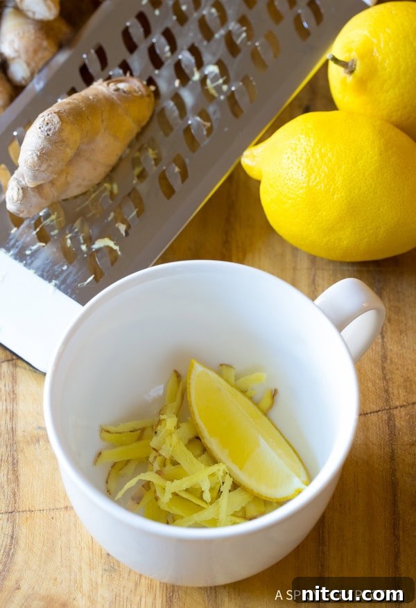 Sunshine Ginger Elixir 6 Grated fresh ginger and a bright lemon wedge waiting in a mug, ready for brewing.