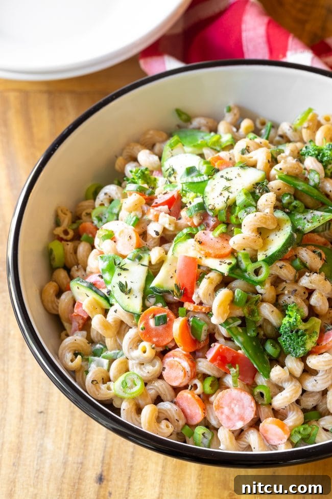 Light & Vibrant Primavera Pasta 8 A wide serving bowl generously filled with vibrant veggie pasta, ready to be enjoyed.