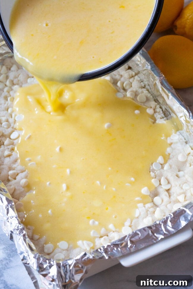 Lemon Bar Recipe #ASpicyPerspective #Lemon #Bars #LemonBars #LemonSquares #CookieCrust #WhiteChocolate #Spring #Dessert #Easter Lemon Bar Recipe