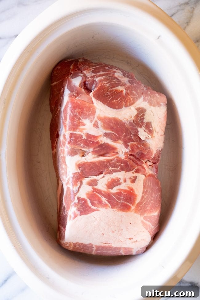 Smoky Perfection: Crockpot Pulled Pork 6 Uncooked pork in a crock-pot.
