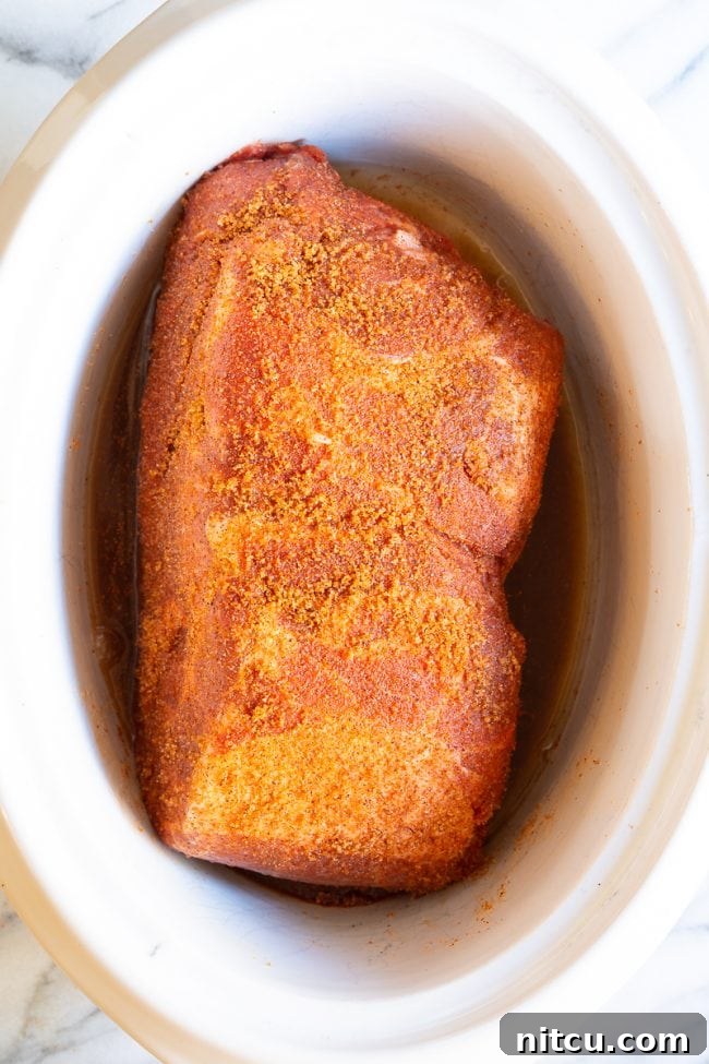 Smoky Perfection: Crockpot Pulled Pork 8 Seasoned pork in a crock-pot.