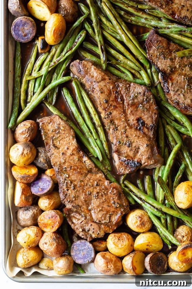 The balsamic steak and veggie sheet pan dinner, fresh out of the oven, with perfectly browned steak and tender vegetables.