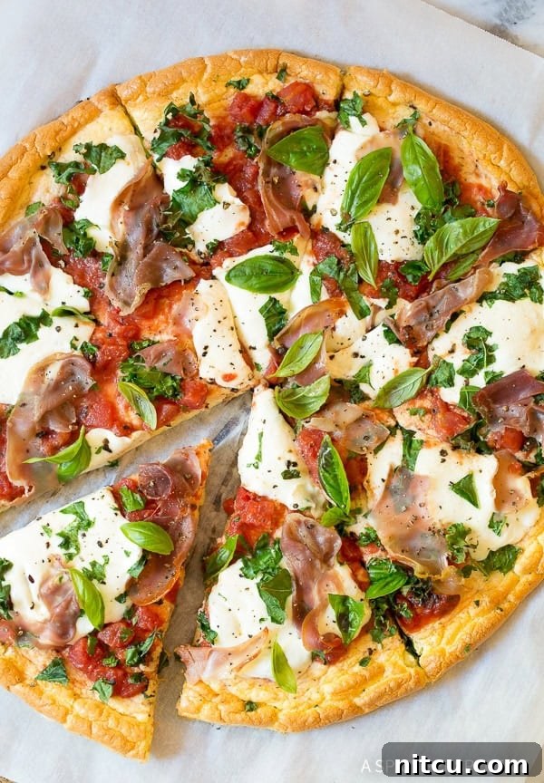 Light & Low Carb Cloud Pizza 2 Overhead shot of low carb cloud bread pizza with mozzarella and prosciutto.