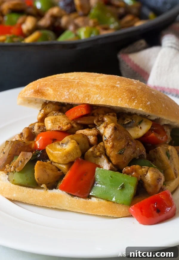 Authentic Croatian Chicken Dinner 3 A close-up shot of Croatian chicken and vegetables generously stuffed into a warm, soft sandwich roll.