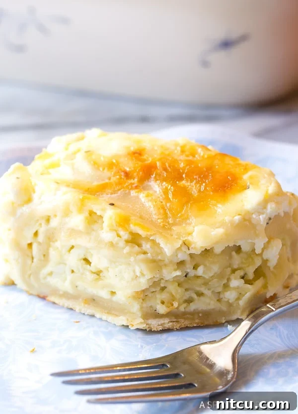 Side view of a slice of strukli on a plate. 
