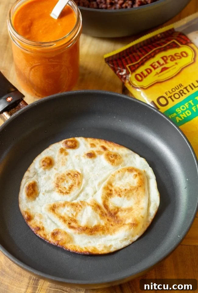 Hearty Ranch Eggs with Zesty Salsa 9 Frying a flour tortilla in a skillet until it puffs up.