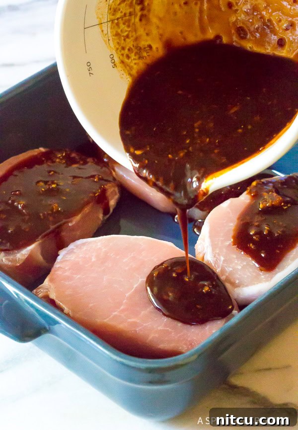 Making Korean Pork Chops - pouring the vibrant marinade over the hot chops in a skillet, creating a rich pan sauce.