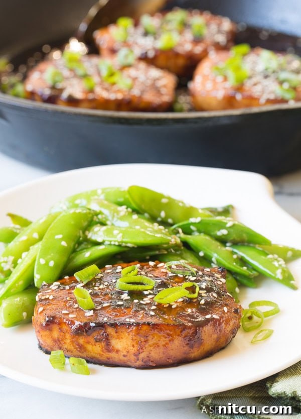 Fried Korean Pork Chops close up on a plate, showcasing the rich glaze and tender interior.