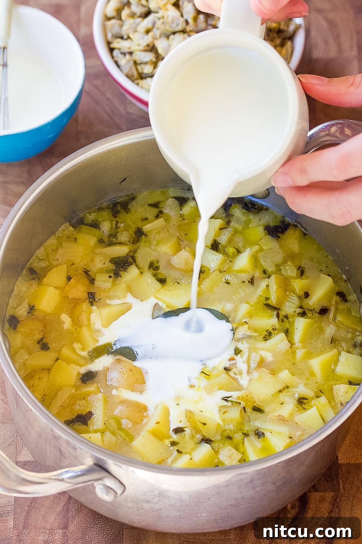 cooking New England Clam Chowder in a large pot