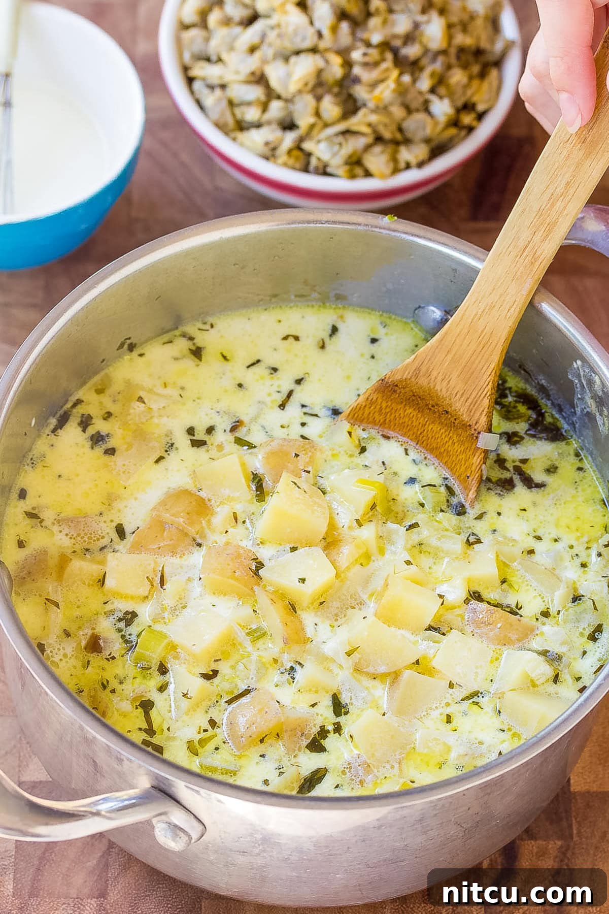 clams in soup with potatoes and herbs, showcasing the rich texture of the chowder