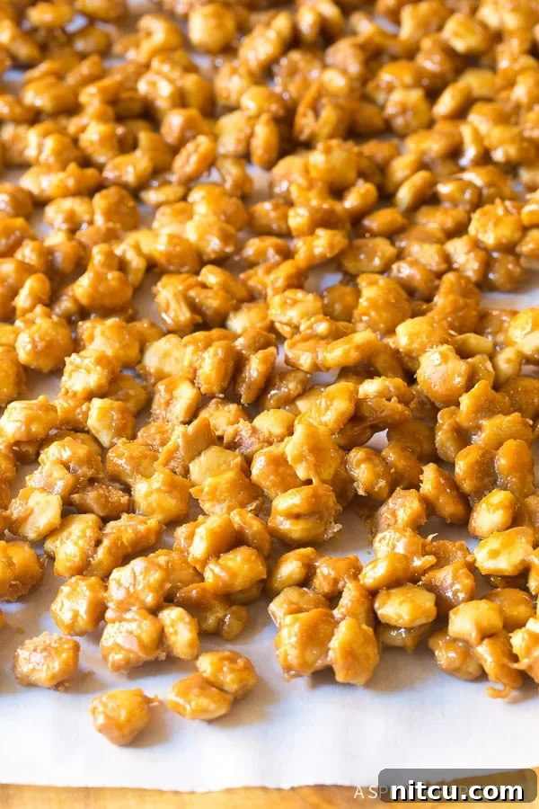 Christmas Toffee Crunch 7 Hardened toffee-coated cracker mixture spread evenly on a baking sheet, cooling down.