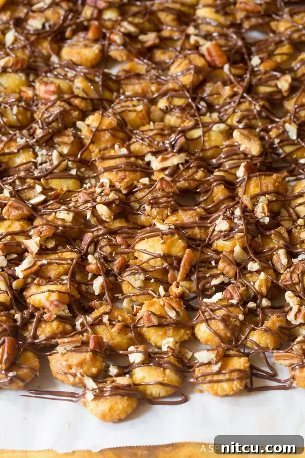 Christmas Toffee Crunch 8 Christmas crack candy drizzled with melted chocolate and sprinkled with chopped nuts, a perfect holiday treat.