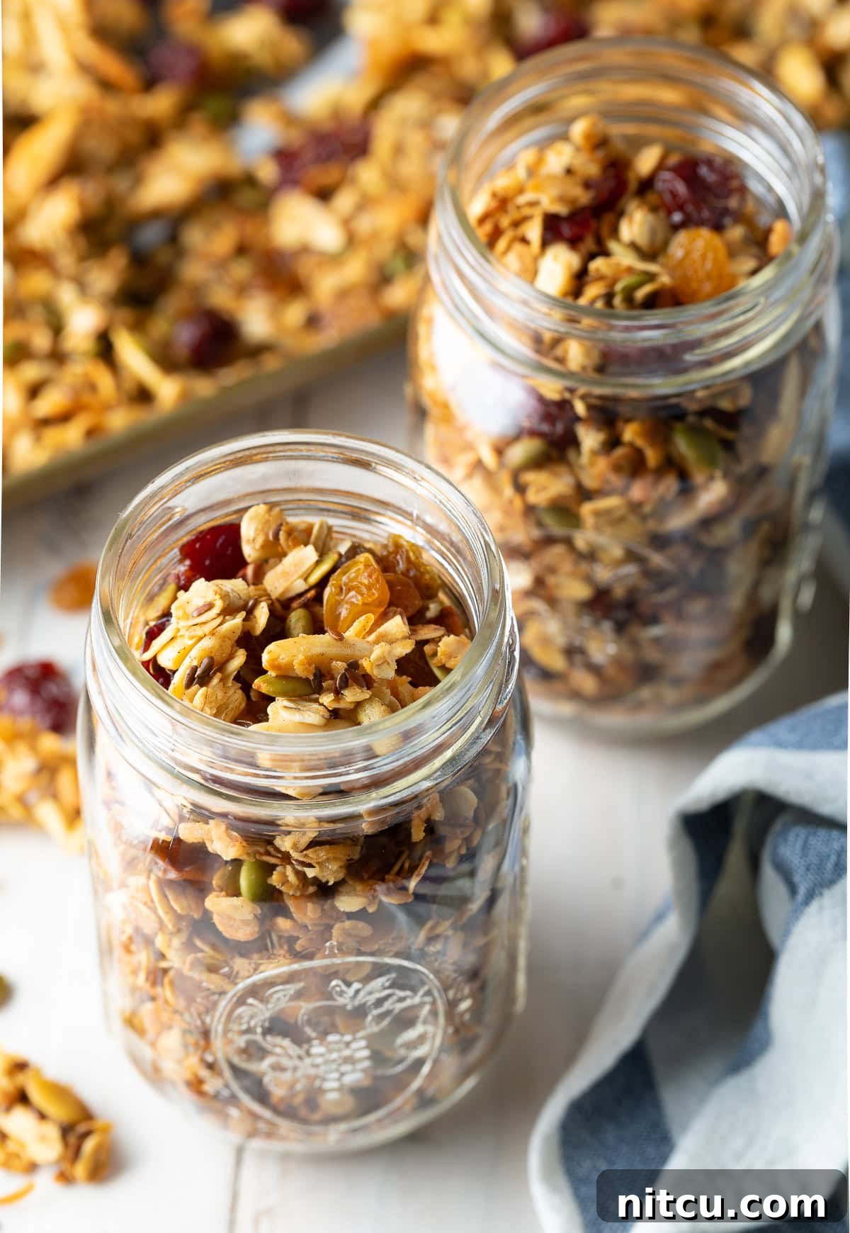 Wholesome Homemade Granola 4 A close-up of homemade granola, richly textured with dried fruit and a variety of nuts and seeds.