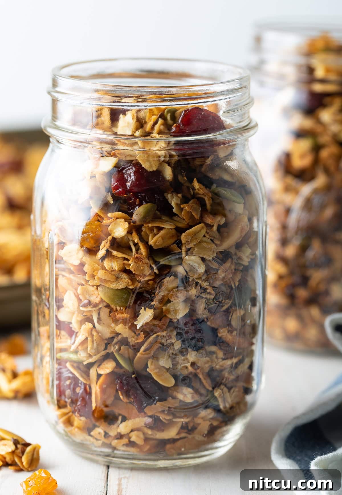 Wholesome Homemade Granola 7 Freshly baked healthy granola cooling on a sheet pan, ready to be stored in a mason jar.