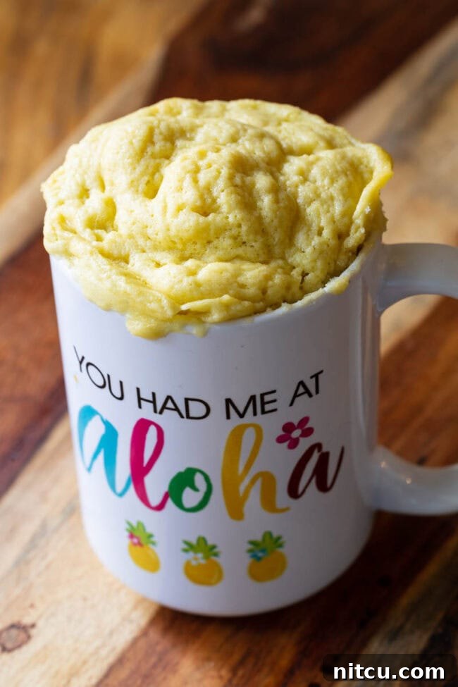 Effortless Keto Mug Bread 5 Mug with microwave bread popping out of the top.