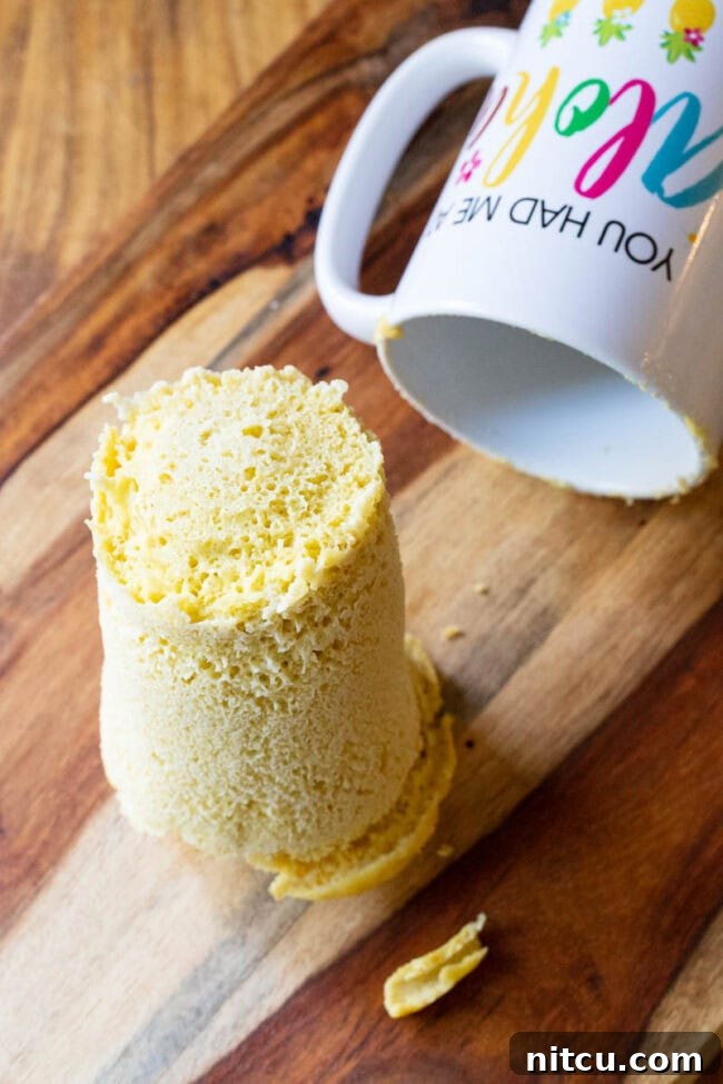 Effortless Keto Mug Bread 6 Loaf of magic mug bread on a cutting board next to the now empty mug.