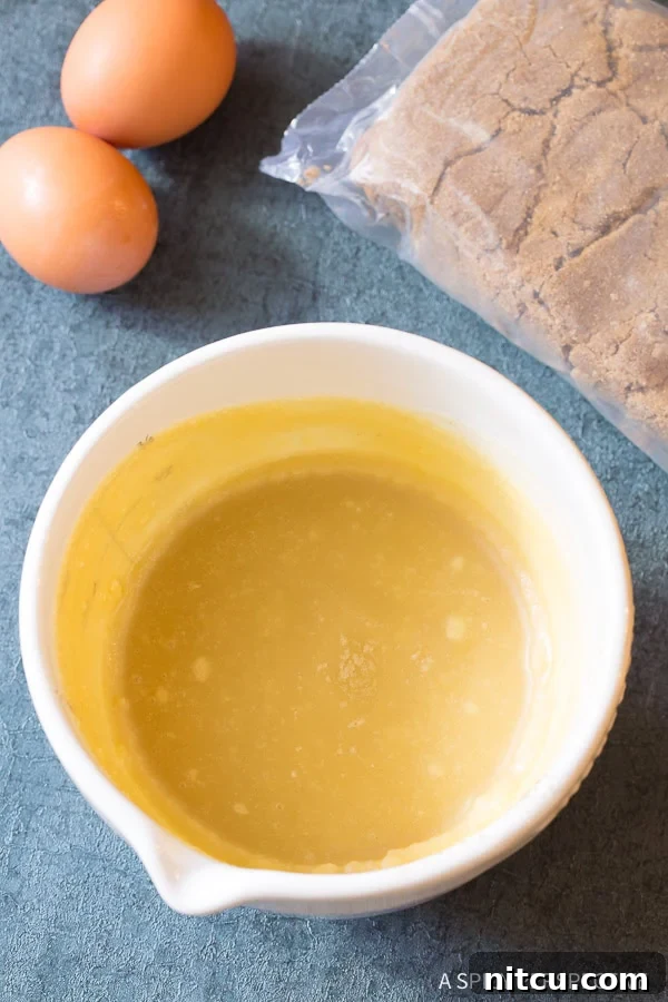 Nutty Brown Butter Delights 6 Blended wet ingredients for brown butter cookies in a mixer bowl.