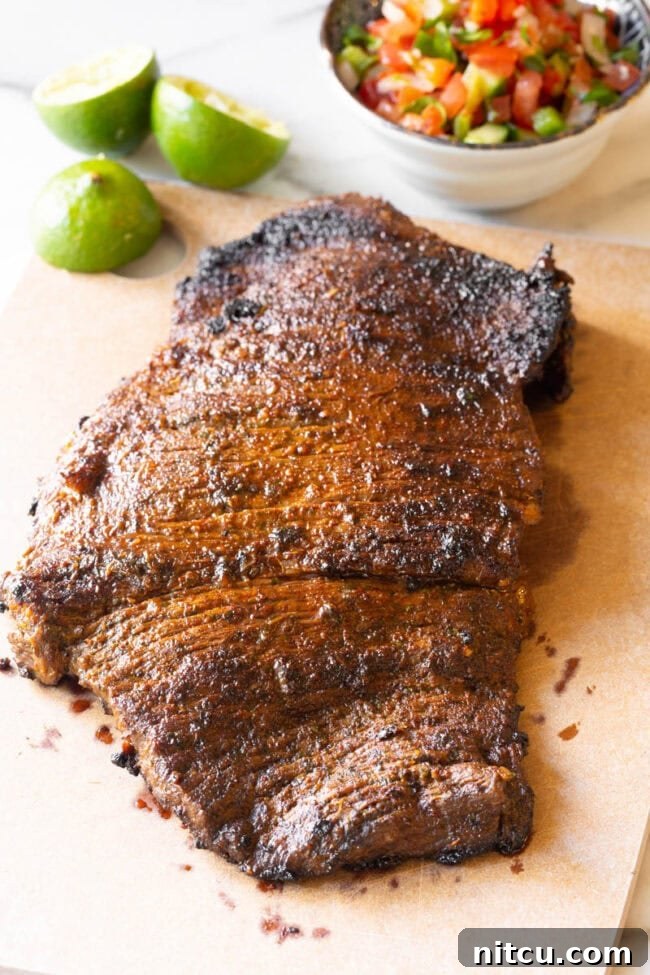 The Secret to Tender Carne Asada 9 Sizzling Carne Asada steak cooking in a hot cast iron skillet, showcasing a perfect sear.