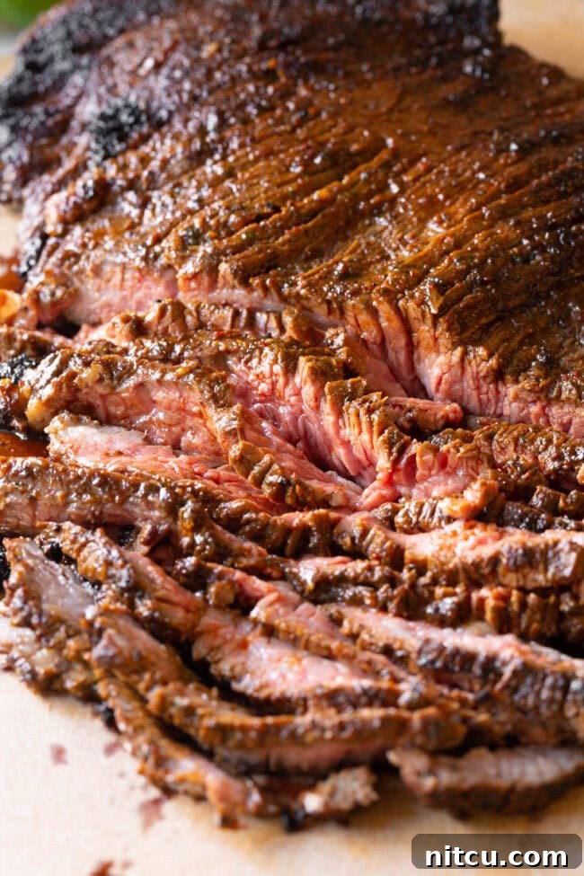 The Secret to Tender Carne Asada 10 Delicious Carne Asada slices served with fresh pico de gallo and lime, ready to be enjoyed.
