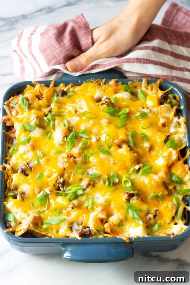 A freshly baked Cool Ranch Dorito Casserole, bubbling with cheese and golden brown, still in its baking dish.