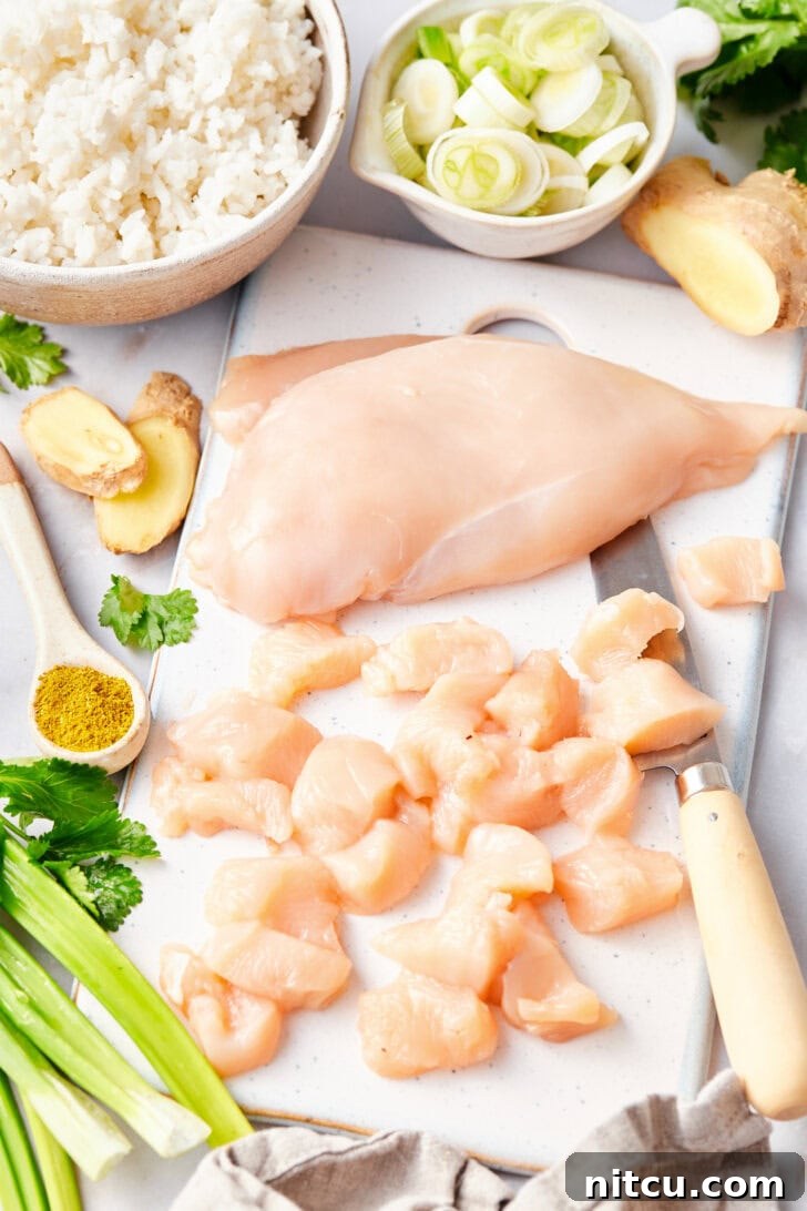 The Ultimate Thai Fried Rice 6 Chopping chicken breast into bite-sized pieces, a crucial first step for this Classic Thai Fried Rice Recipe.