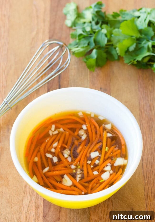 Nuc Cham Sauce in a small bowl with a whisk next to it. 