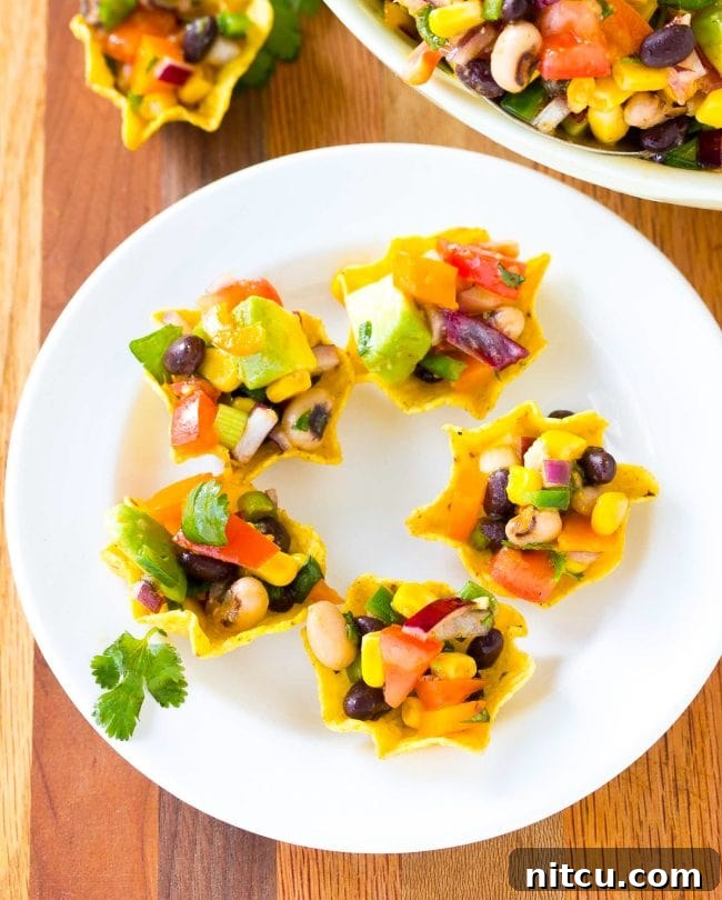 Cowboy caviar elegantly scooped into small tortilla shells, ready for a party.