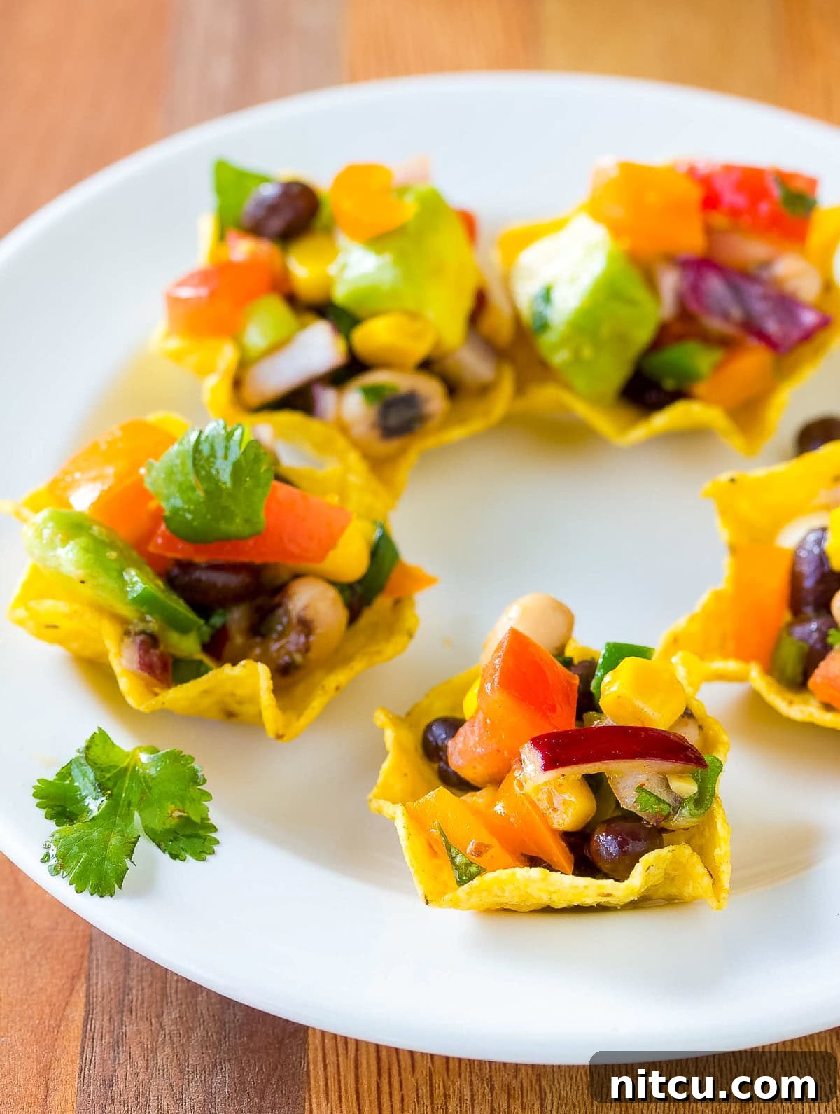 Cowboy caviar generously scooped into tortilla chips.