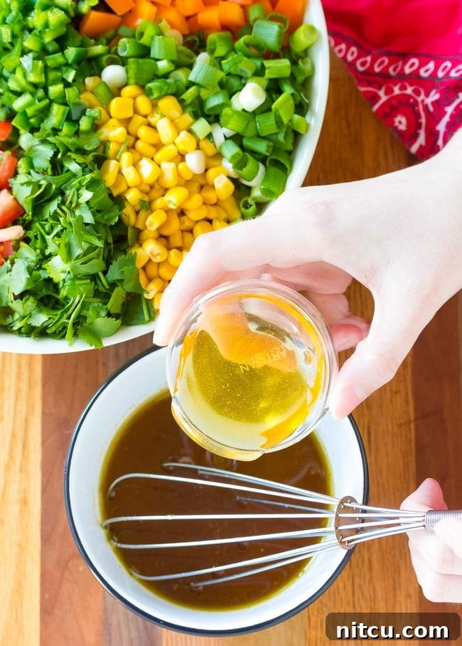 Ingredients being whisked together to create the marinade dressing.