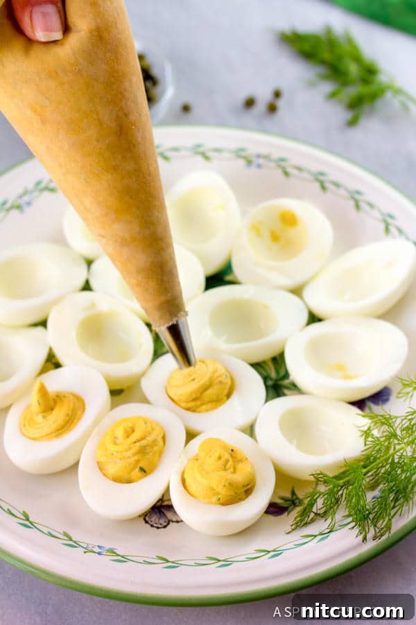 Heavenly Deviled Eggs 7 Piping filing into egg whites