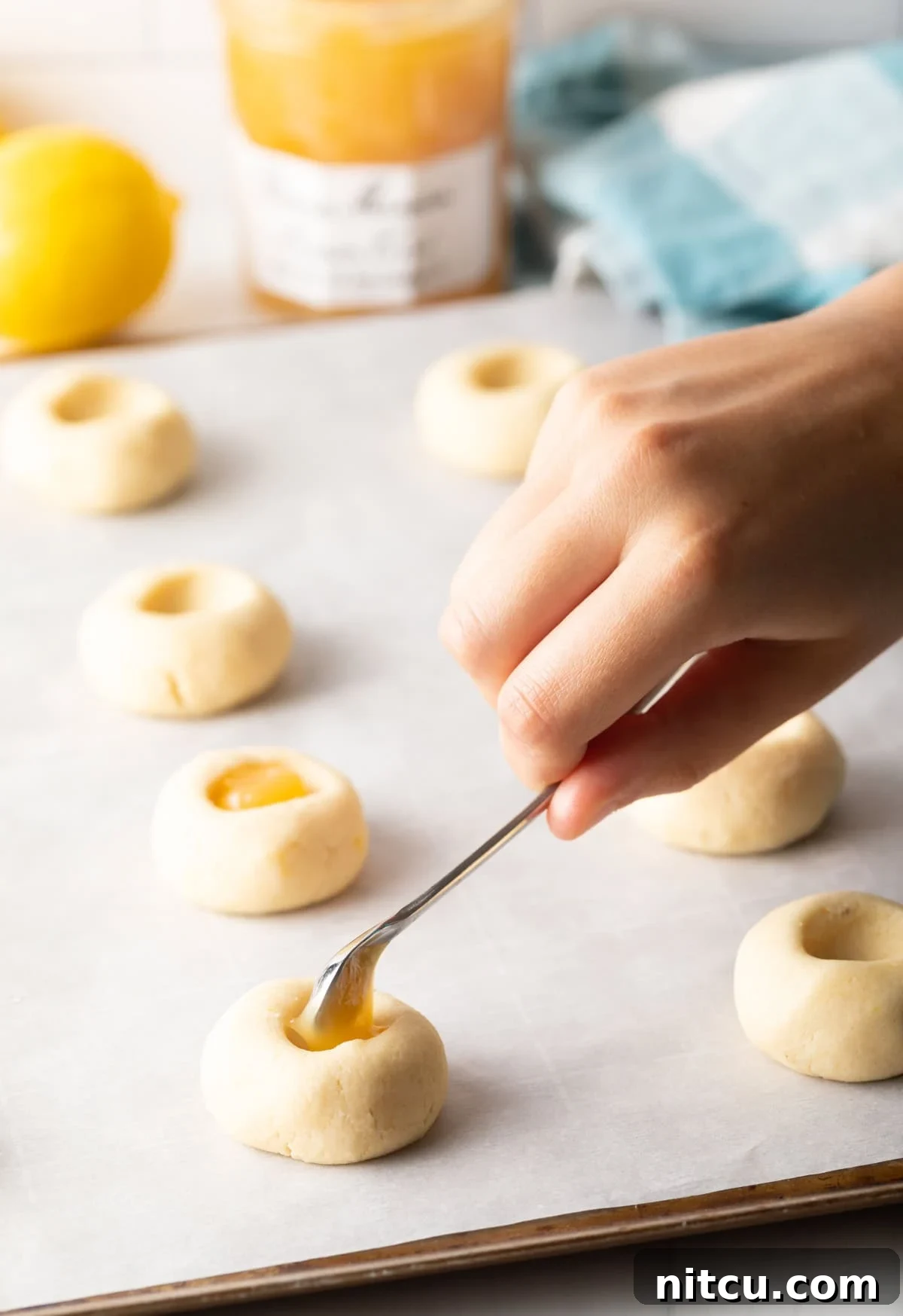 Sunshine Lemon Drop Cookies 5 Using the smallest little spoon to put a dollop of custard into the indent of the dough