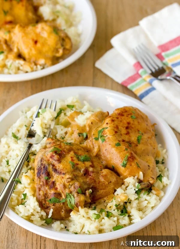 Soulful Hungarian Paprika Chicken 8 A serving of Chicken Paprikash with sauce on a plate, alongside a fork and napkin
