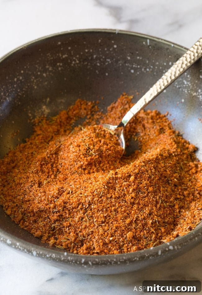 Mixing the Best Steak Seasoning Steak seasoning in a small bowl with a little spoon, ready for use.