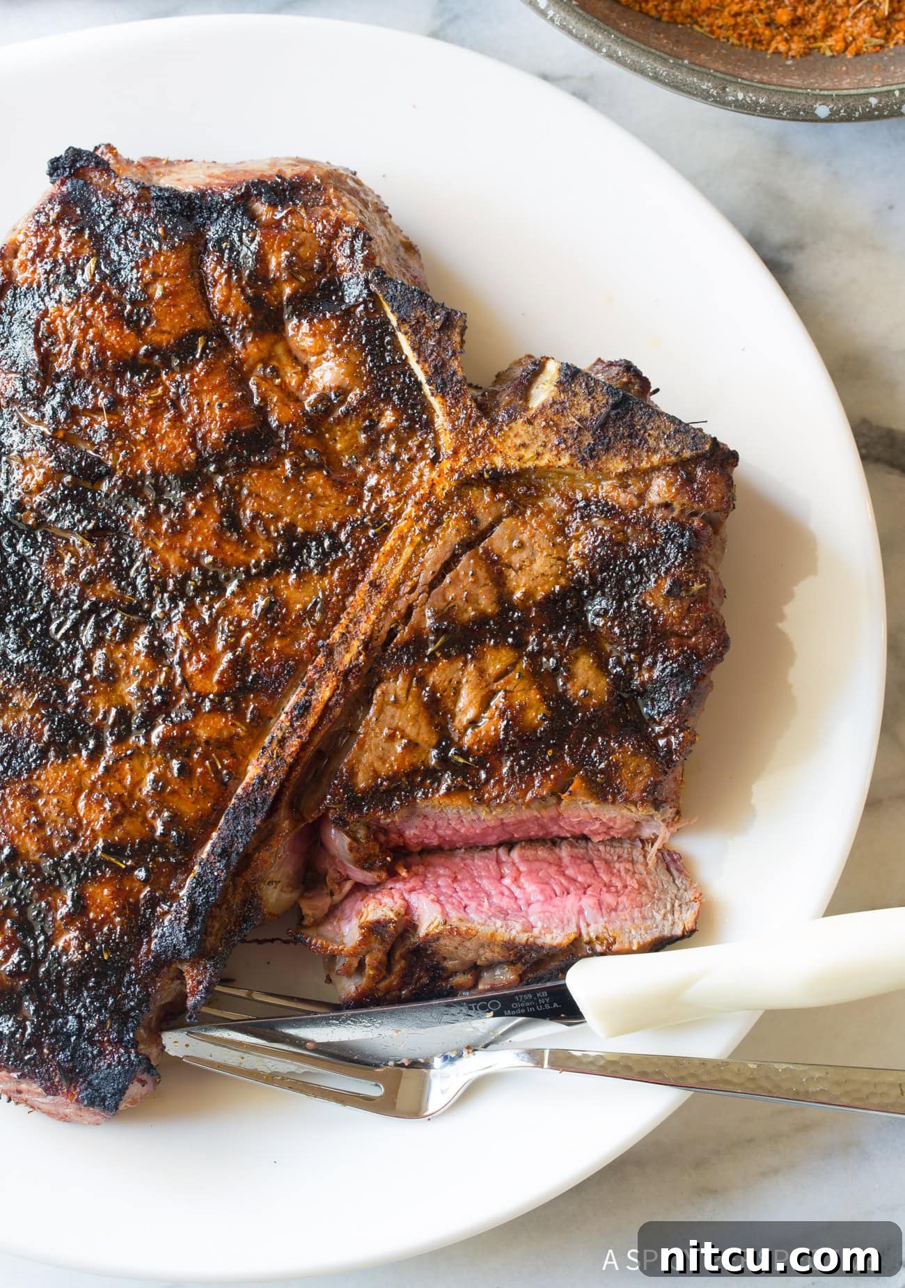 Medium Rare Steak Perfection A medium-rare steak, sliced open to reveal its perfectly pink interior, rests on a plate, showcasing ideal doneness.