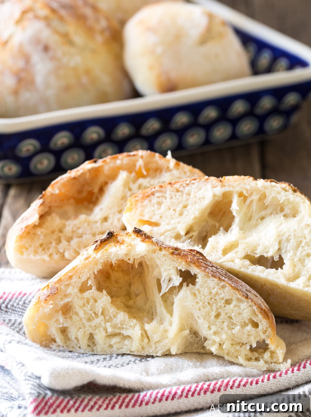 Pillowy Croatian Lepinja: Authentic Flatbread Recipe 4 Bubbly Lepinja Bread Recipe - loaves cut open to expose air bubbles.