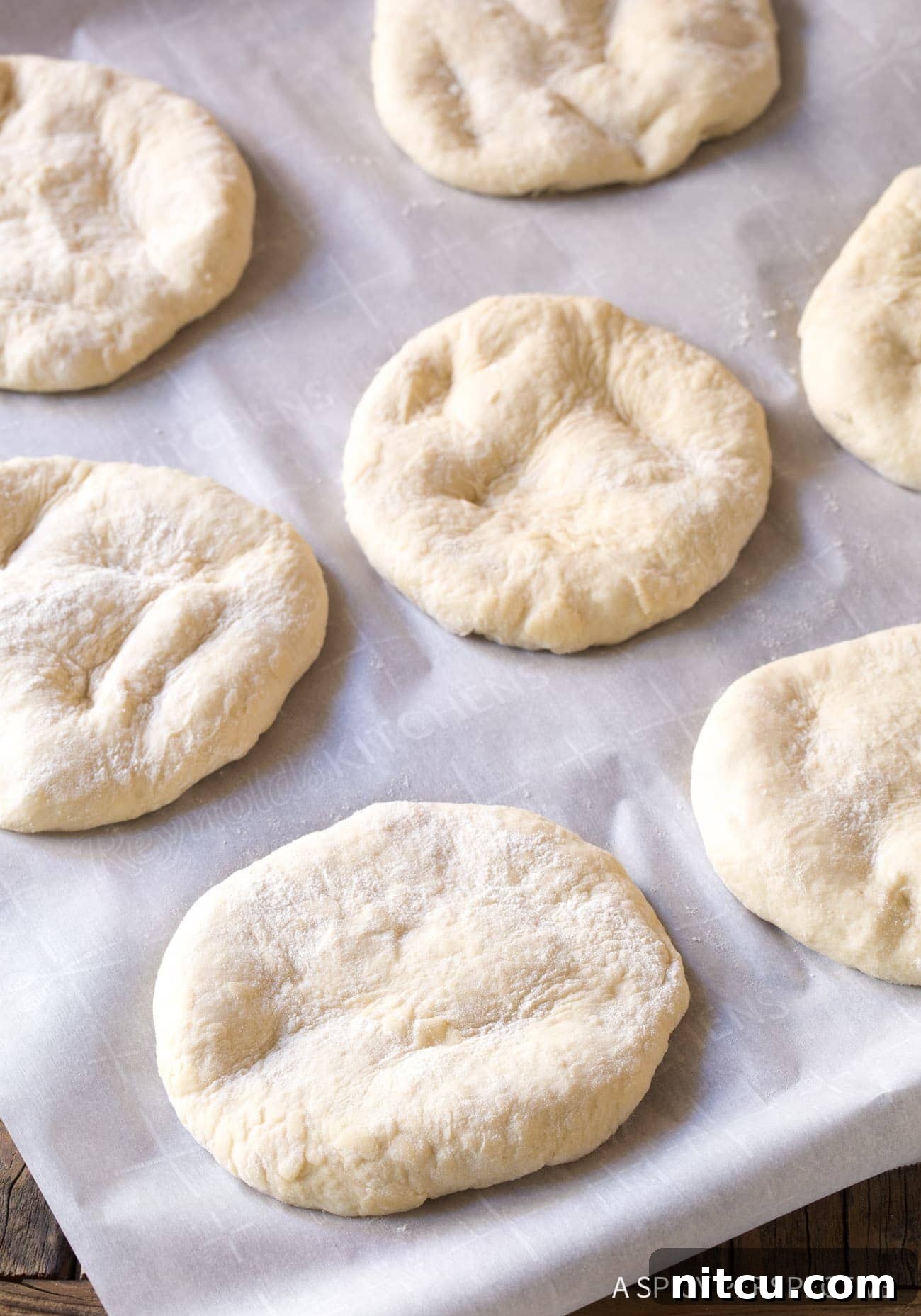 Pillowy Croatian Lepinja: Authentic Flatbread Recipe 6 Lepinja Bread - disks of dough on baking sheet.