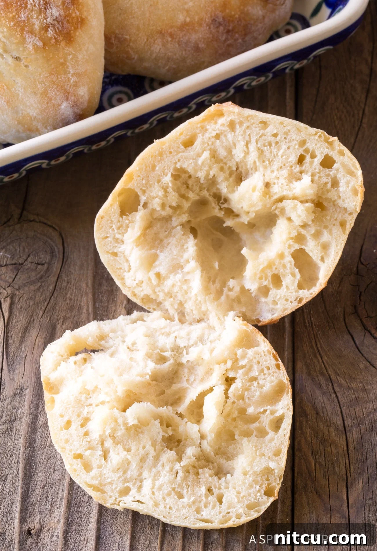 Pillowy Croatian Lepinja: Authentic Flatbread Recipe 8 Croatian Lepinja Bread cut open on wooden board.