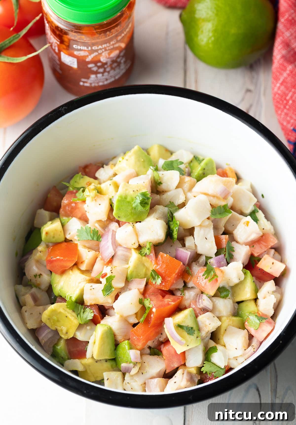 Swai-Ceviche Ceviche de Pescado in bowl with fresh produce - mix together