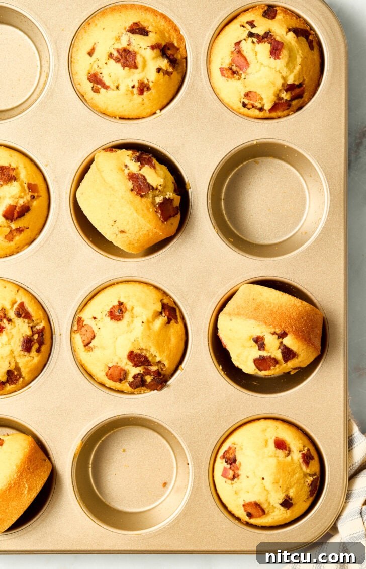Golden Corn Muffins with Crispy Bacon 11 Delicious warm cornbread muffins in a baking pan with bacon and maple syrup