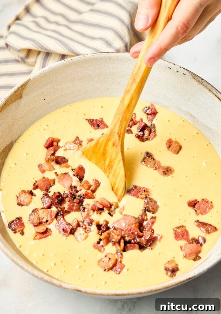 Golden Corn Muffins with Crispy Bacon 7 Chopped bacon mixed into cornbread muffin batter in a bowl
