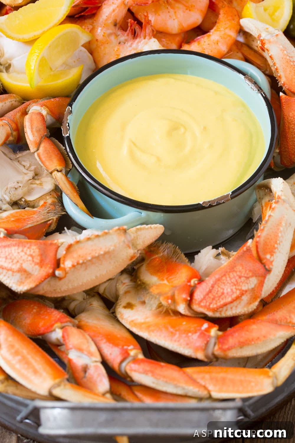 Only-5-Ingredient-Seafood-Sauce Shrimp, crab, and lemon wedges beautifully arranged on a platter, with a small bowl of yellow seafood mustard sauce ready for dipping.