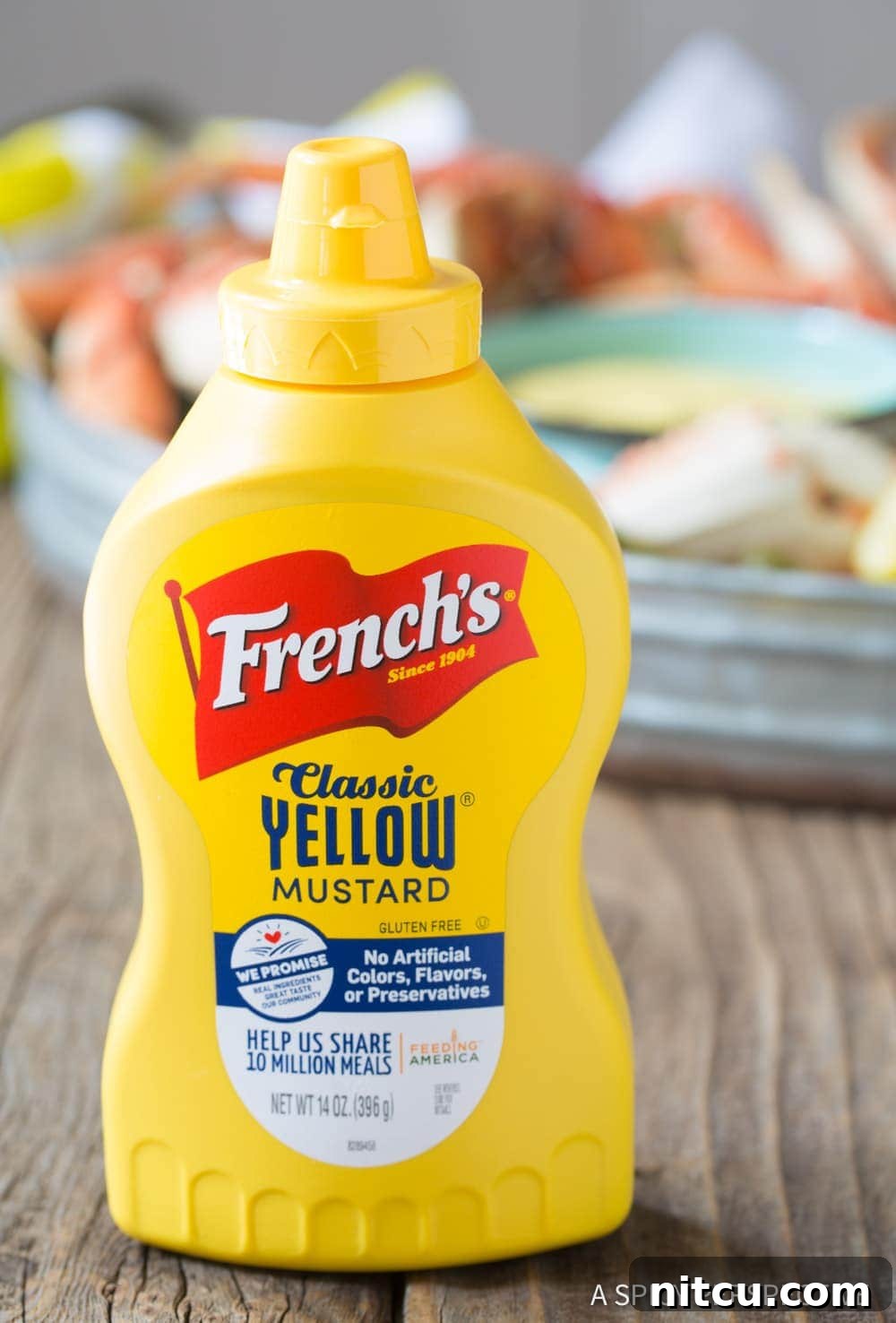 French's-Classic-Yellow-Mustard A bottle of French's Classic Yellow Mustard, highlighted as a key ingredient for the seafood sauce.