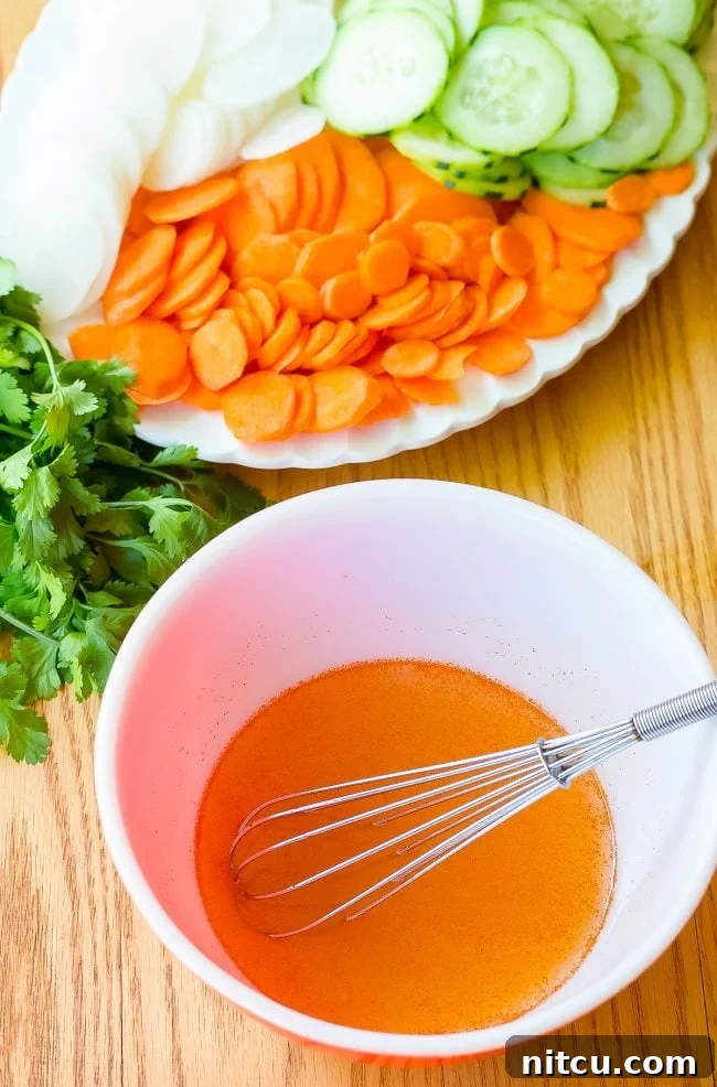 Vietnamese Baguette Masterpiece 4 Banh Mi ingredients laid out with chicken marinating in a bowl