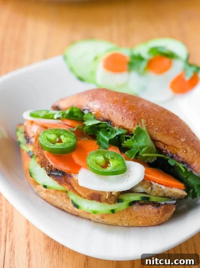 Vietnamese Baguette Masterpiece 7 Close-up of a Banh Mi sandwich on a plate with fresh vegetables