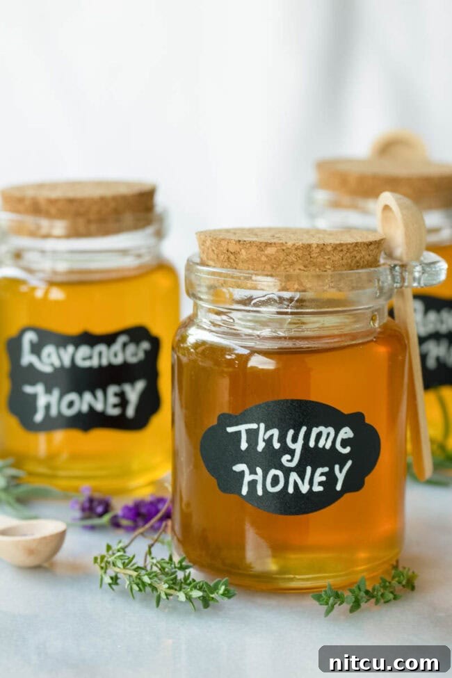 Honey Elixirs 4 Three small jars of honey labeled 'thyme honey', 'lavender honey', and 'rosemary honey'.