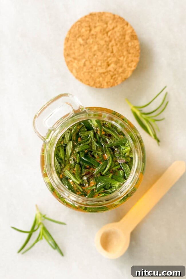 Honey Elixirs 5 Infused Honey Recipe - Overhead shot of herbs soaking in the honey in a small jar.