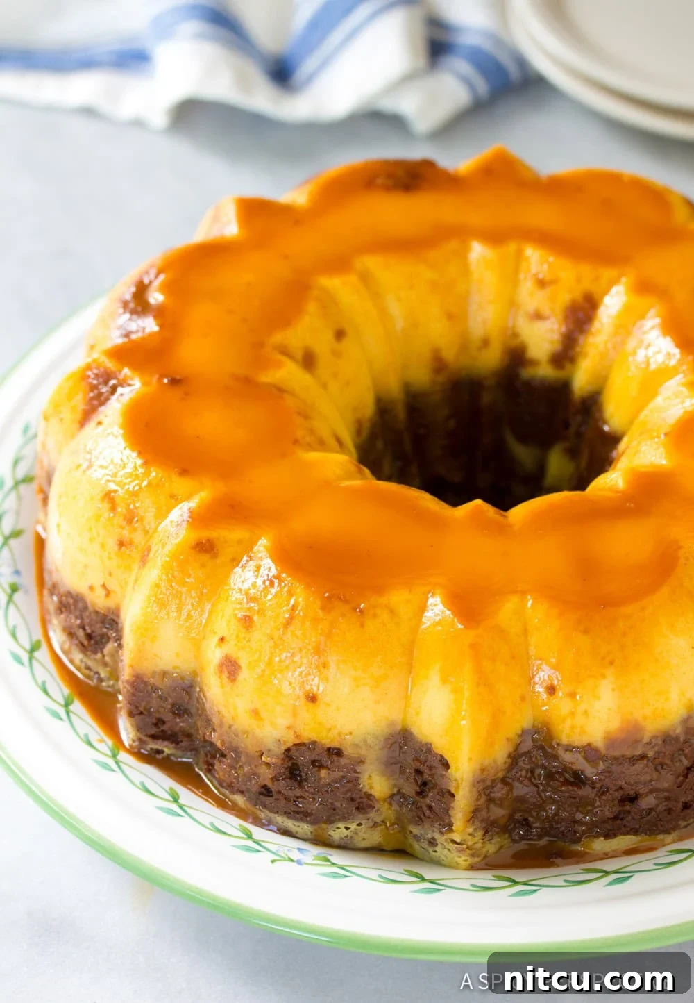 Impossible Chocoflan Cake 11 A whole Chocoflan cake sitting on a serving platter, ready to be sliced and served.
