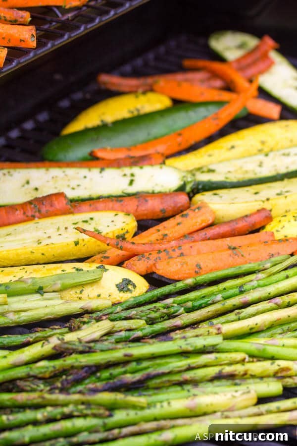 Flame-Kissed Pork Tenderloin with Bright Chimichurri and Rustic Roast Vegetables 6 Assorted vegetables including zucchini, squash, and carrots roasting on a hot grill, showing developing char marks and vibrant colors against the grill grates.